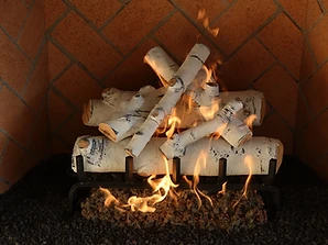 Gas fireplace with white birch ceramic logs on a herringbone brick interior